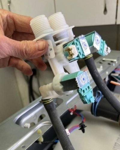 Washing machine water inlet valve being replaced to fix an error code fault